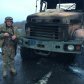 украинский военный на фоне разбитого грузовика боевиков